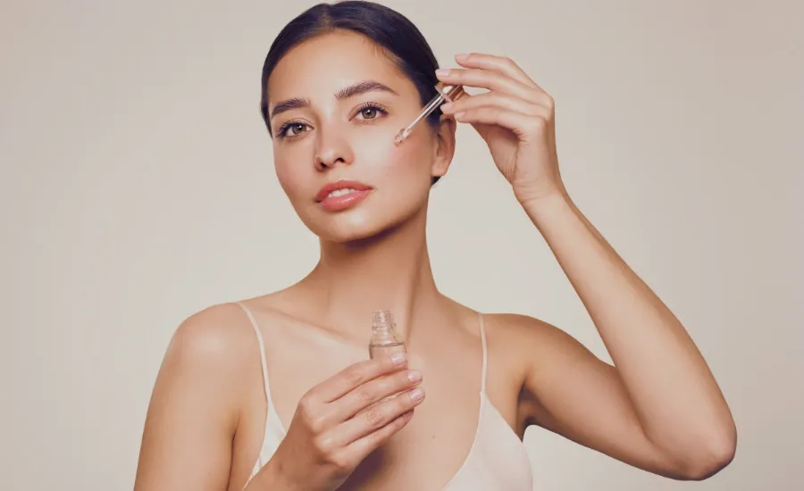 woman applying peptide serum