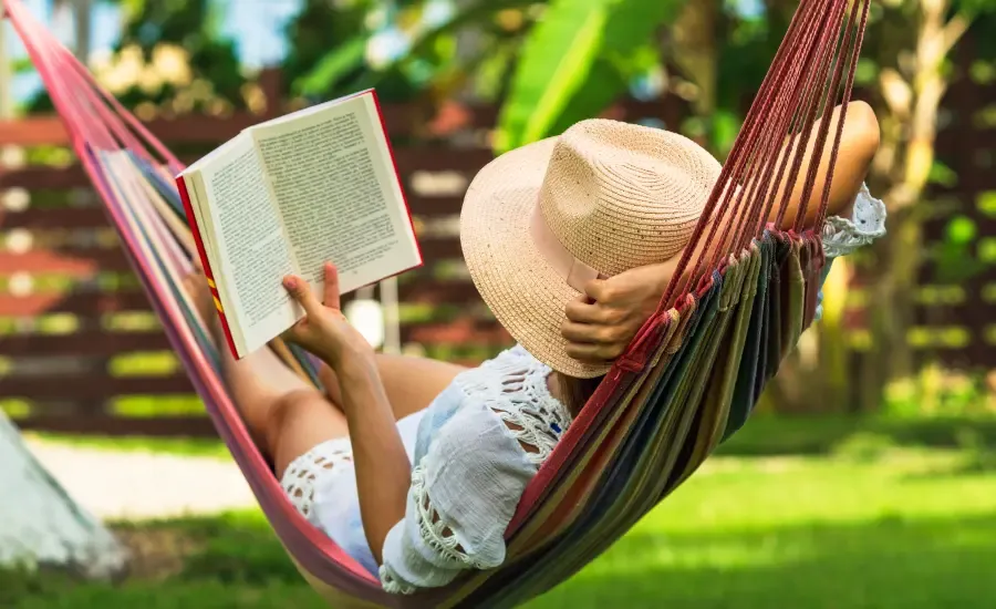 woman in hammock reading book