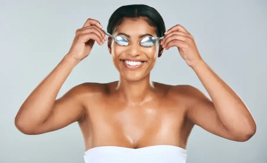 woman with two spoons in her eyes
